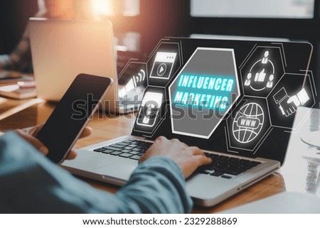 Influencer marketing concept, Person working on laptop computer with Influencer marketing icon on virtual screen.