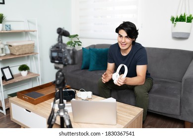 Influencer and tech geek reviewing some cool gadgets he just received while talking to his online audience - Shutterstock ID 1830367541