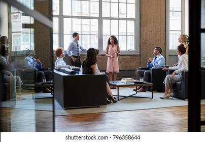 Informal Business Meeting Seen Through Open Glass Doors