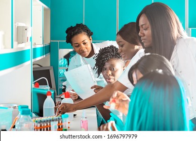 Informal Team Discussion. African Medics, Technical Assistants, Scientists, Young Women Work In Research Laboratory, Medical Test Lab. Quality Control Of Various Substances