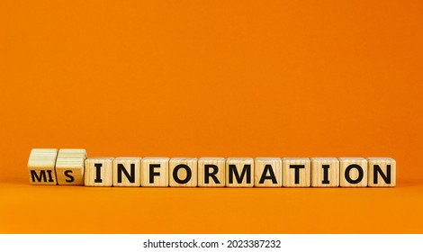 Information or misinformation symbol. Turned cubes and changed the word misinformation to information. Orange background, copy space. Business and information or misinformation concept.