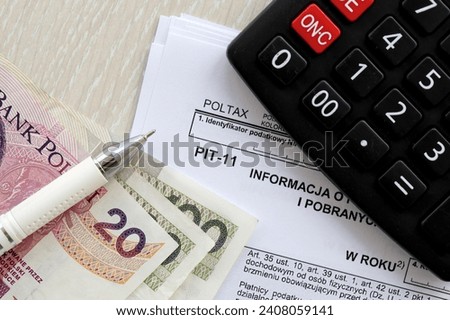 Information on revenues from other sources and collected income tax advances, PIT-11 form on accountant table with pen and polish zloty money bills close up