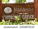 Information sign at the entrance to Hanapepe Swinging Bridge, Kauai, Hawaii on a sunny day, no people