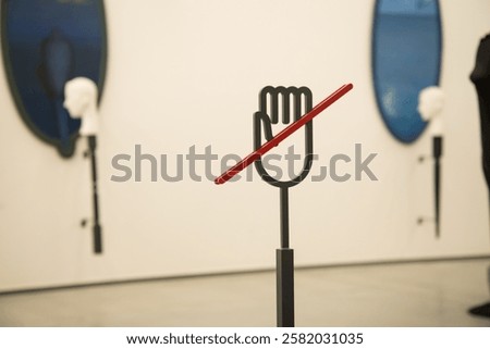 Information stand "Do not touch" symbol made from steel in modern contemporary art gallery. Prohibition, don't touch sign and symbol concept.