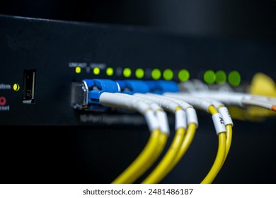 Information technology room computer network ether cable Fiber optic cables and telecommunications net connected to internet switches.