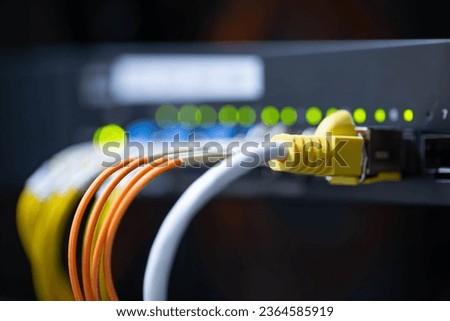 Information technology room computer network ether cable Fiber optic cables and telecommunications net connected to internet switches.