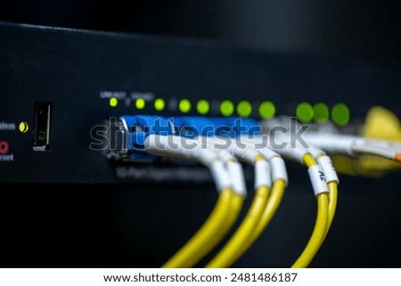 Information technology room computer network ether cable Fiber optic cables and telecommunications net connected to internet switches.