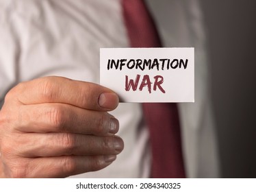 Information war text on paper. Concept of mass media influence.