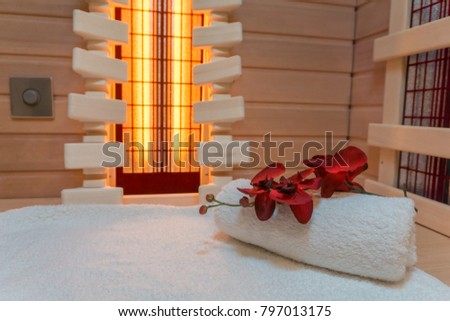 Infrared cabin interior with a white towel and a wonderful flower