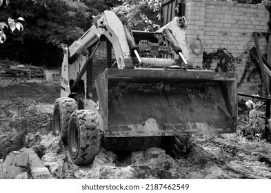 Infrared filter. Bulldozer on old house rebuilding. 11 July 2022. Kiev Region, Ukraine