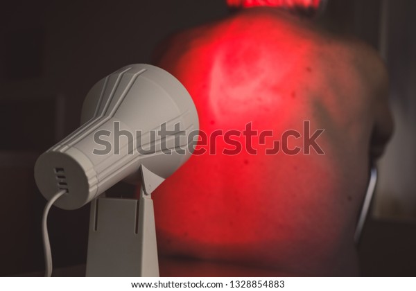 Infrared radiation heat light lamp therapy. Senior\
back pain