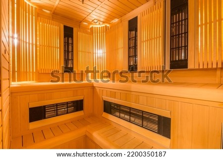 Infrared sauna. Interior design of a wooden, softly lit sauna with benches.