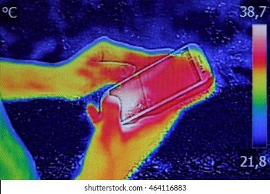 Infrared Thermography Image Showing The Heat Emission When Young Girl Used Smartphone Or Cell Phone