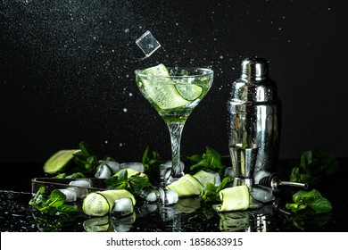 Infused cucumber drink with mint. Detox water on a black reflective background. drink in freeze motion, drops in liquid splash. - Shutterstock ID 1858633915