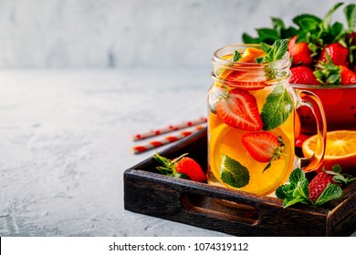 Infused Detox Water With Orange, Strawberry And Mint. Ice Cold Summer Cocktail Or Lemonade In Glass Mason Jar