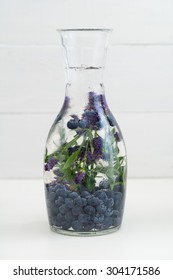 Infused Water With Blueberries And Lavender In A Pitcher