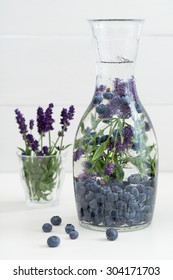 Infused Water With Blueberries And Lavender In A Pitcher