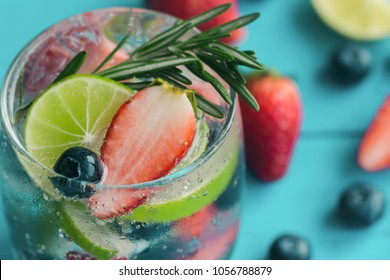 Infused water made from blueberry strawberry and lemon in sparkling mineral water look so freshness and healthy.Mixed fruit mojito on blue wood table with copy space. Summer refreshing drink concept. - Powered by Shutterstock