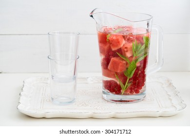 Infused Water With Watermelons, Red Currants And Mint In A Pitcher