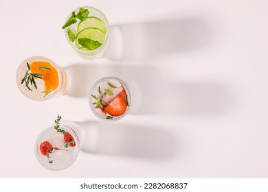 Infused waters with different flavors, summer refreshing drinks in a ribbed glasses, top view - Powered by Shutterstock