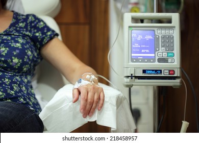 Infusion Pump Feeding IV Drip Into Patients Arm Focus On Needle