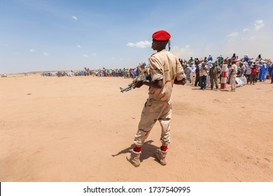 Ingall, Niger - September 2013: Armed Soldier In Desert Landscape 