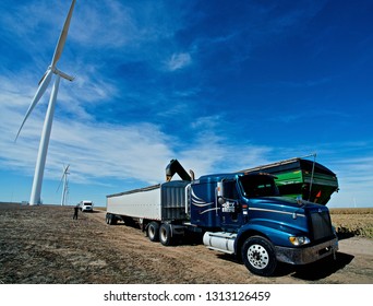 Ingalls, Kansas, USA, October 23, 2014
A John Deere Combine Sends Its Load Of Harvested Milo Grain From It's Storage Hopper Thru It's Discharge Tube Into The Bed Of A Waiting Tractor Trailer Hauler