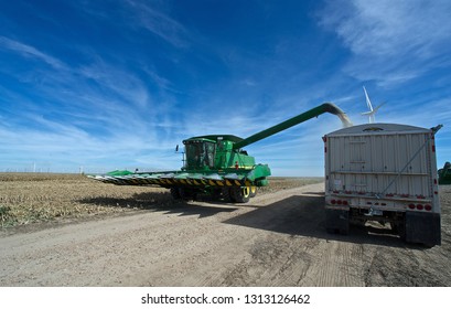 Ingalls, Kansas, USA, October 23, 2014
A John Deere Combine Sends Its Load Of Harvested Milo Grain From It's Storage Hopper Thru It's Discharge Tube Into The Bed Of A Waiting Tractor Trailer Hauler