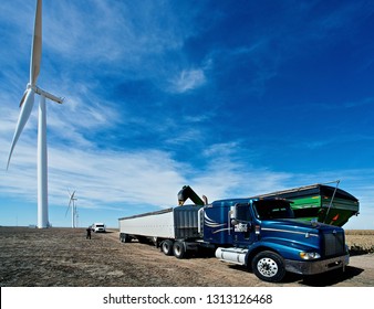 Ingalls, Kansas, USA, October 23, 2014
A John Deere Combine Sends Its Load Of Harvested Milo Grain From It's Storage Hopper Thru It's Discharge Tube Into The Bed Of A Waiting Tractor Trailer Hauler