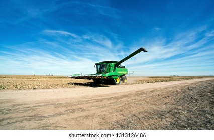 Ingalls, Kansas, USA, October 23, 2014
A John Deere Combine Sends Its Load Of Harvested Milo Grain From It's Storage Hopper Thru It's Discharge Tube Into The Bed Of A Waiting Tractor Trailer Hauler