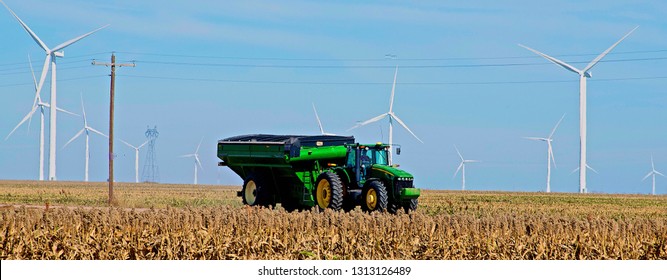 Ingalls, Kansas, USA, October 23, 2014
A John Deere Combine Sends Its Load Of Harvested Milo Grain From It's Storage Hopper Thru It's Discharge Tube Into The Bed Of A Waiting Tractor Trailer Hauler