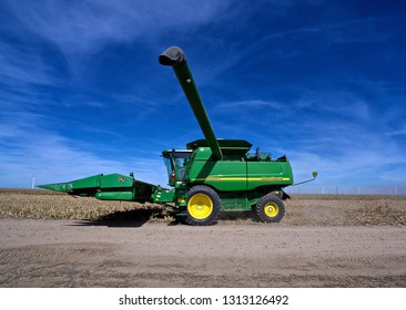 Ingalls, Kansas, USA, October 23, 2014
A John Deere Combine Sends Its Load Of Harvested Milo Grain From It's Storage Hopper Thru It's Discharge Tube Into The Bed Of A Waiting Tractor Trailer Hauler