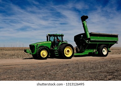 Ingalls, Kansas, USA, October 23, 2014
A John Deere Combine Sends Its Load Of Harvested Milo Grain From It's Storage Hopper Thru It's Discharge Tube Into The Bed Of A Waiting Tractor Trailer Hauler