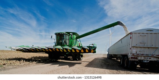 Ingalls, Kansas, USA, October 23, 2014
A John Deere Combine Sends Its Load Of Harvested Milo Grain From It's Storage Hopper Thru It's Discharge Tube Into The Bed Of A Waiting Tractor Trailer Hauler