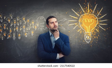 Ingenious businessman gathering ideas as joining all the lightbulbs into one big and bright bulb. Genius creativity and positive thinking concept