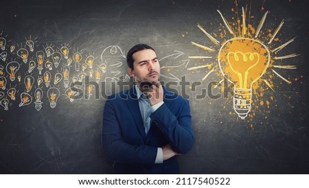 Ingenious businessman gathering ideas as joining all the lightbulbs into one big and bright bulb. Genius creativity and positive thinking concept