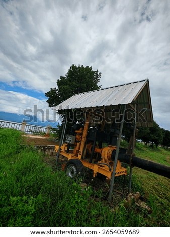 An ingenious movable setup: a rustic wooden pavilion featuring an iron roof, designed for well oil production and creating essential pipes for workers tending rice fields.