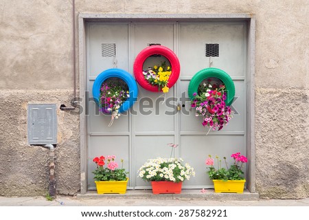 Ingenious, original and environmentally friendly method of recycling of tires car as planters in a village in Tuscany.