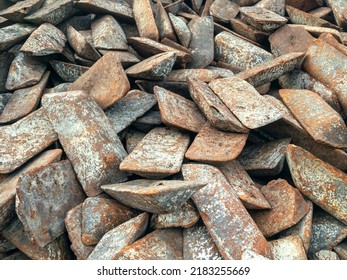Ingots of cast iron stored in the warehouse. The form of cast iron: ingots, ingots solid condition. Transfer cast iron is cast iron used for further processing into steel.