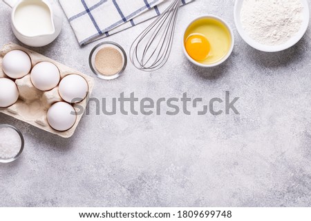 Ingredients for baking - flour, milk, salt, sugar, eggs. Top view, copy space.