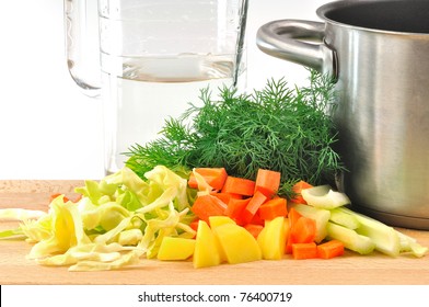 INGREDIENTS Cabbage Soup CUT Vegetables On A Board With The Pots And Jug Of Water