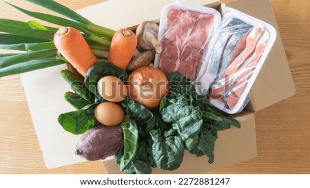 Ingredients in cardboard.Home delivery service for vegetables, meat, fish and eggs. ストックフォト © 