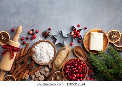 Ingredients for cooking Christmas baking. Flour, sugar, butter, cranberry and spices on kitchen table top view. Bakery background. - Powered by Shutterstock