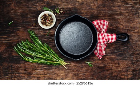 Ingredients for cooking and empty cast iron skillet