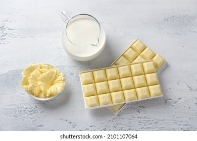 Ingredients For Cooking Homemade Candy: White Chocolate, Butter And Heavy Cream On A Light Blue Background, Top View