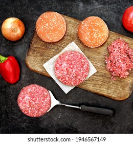 Ingredients For Cooking Steak Burgers Or Cheeseburger, Overhead View. Raw Ground Beef Meat Cutlets Or Patties On Wooden Chopping Board. Homemade Cooking Food For Family Party, Top View.