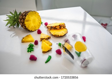 Ingredients For Fruit Smoothie On A White Table: Pineapple, Raspberry, Menthol