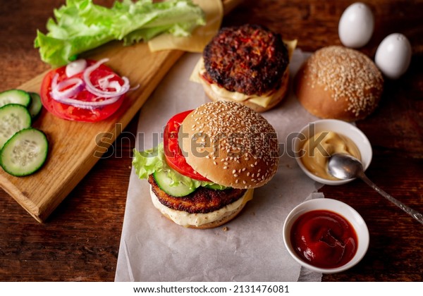 Ingredients for\
hamburger, cheeseburger. Wooden background. Home cooking hamburger.\
Food concept. Hamburger\
day.
