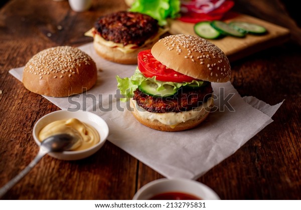 Ingredients for\
hamburger, cheeseburger. Wooden background. Home cooking hamburger.\
Food concept. Hamburger\
day.