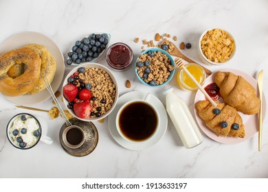 Ingredients for a healthy breakfast, nuts, oatmeal, honey, berries, fruits, blueberry, almonds, walnuts. The concept of natural organic food in season. Top view - Powered by Shutterstock